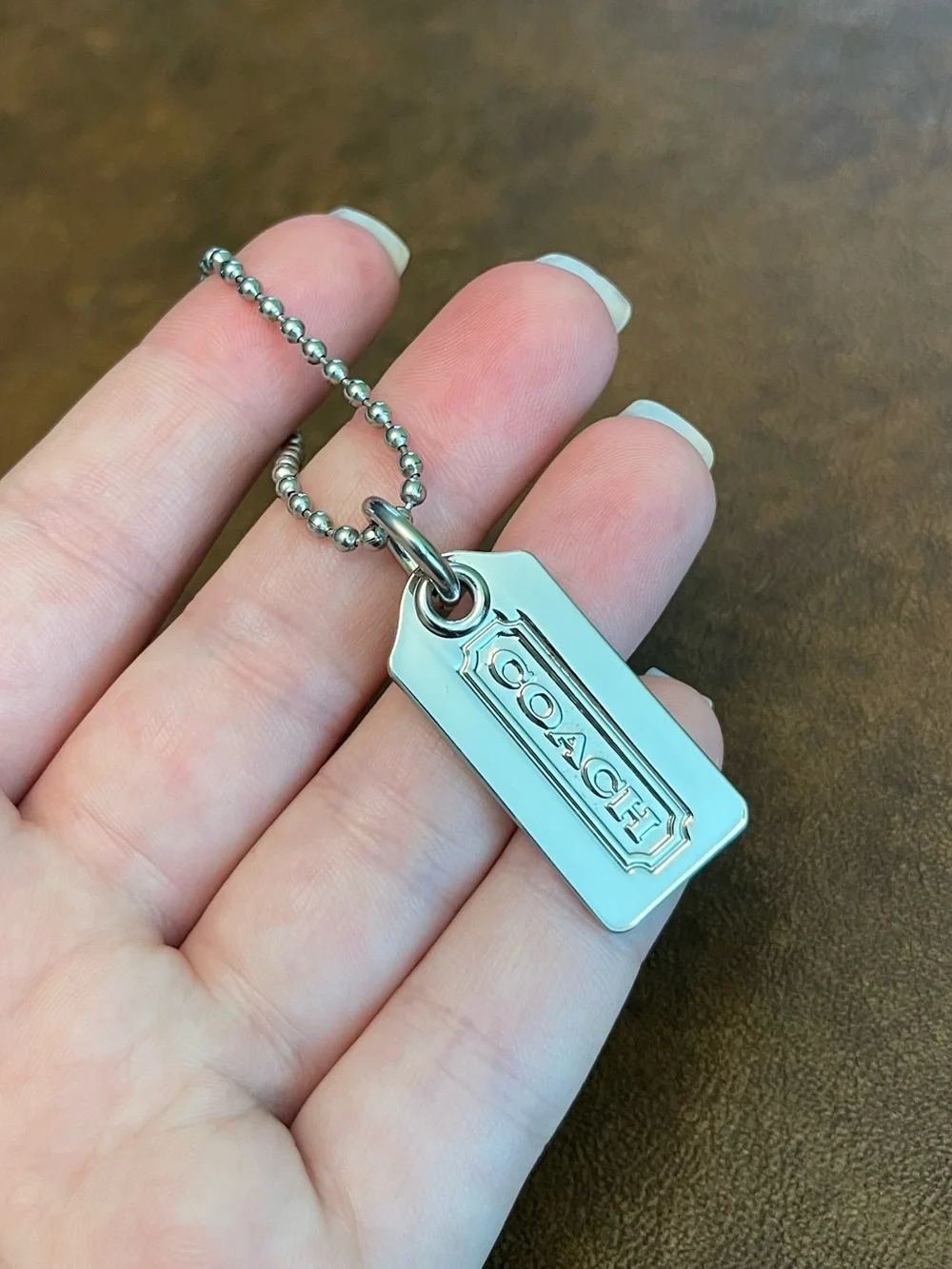 Coach silver metal hangtag